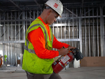 Technician servicing fire extinguisher