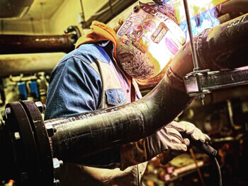 Man working on piping system fabrication