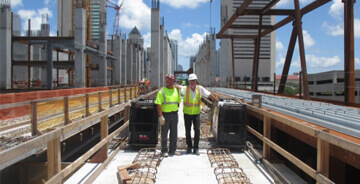 Two S.A. Comunale workers on a job site in safety gear